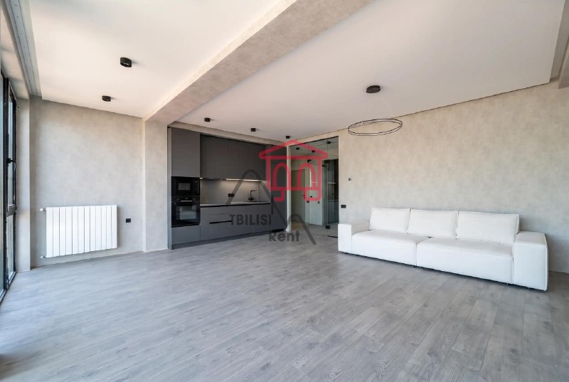 A bright apartment is for sale in a new building in the center of Saburtalo. The apartment has undergone full renovation and features three high-quality air conditioning systems throughout, two bathrooms, and panoramic windows. The owner will install interior doors. The apartment is almost completely ready to move in. — фото 1